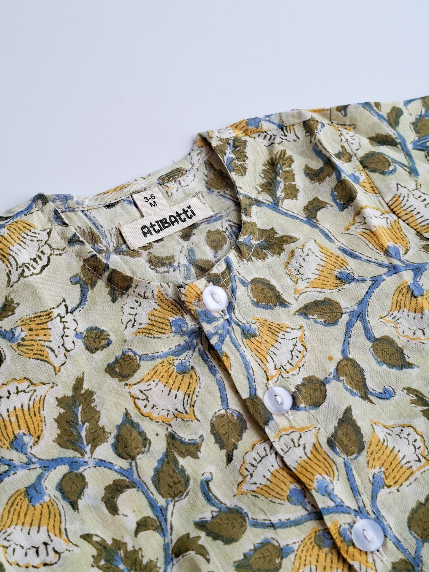Yellow floral handblock printed mulmul cotton jhabla for newborn baby close view
