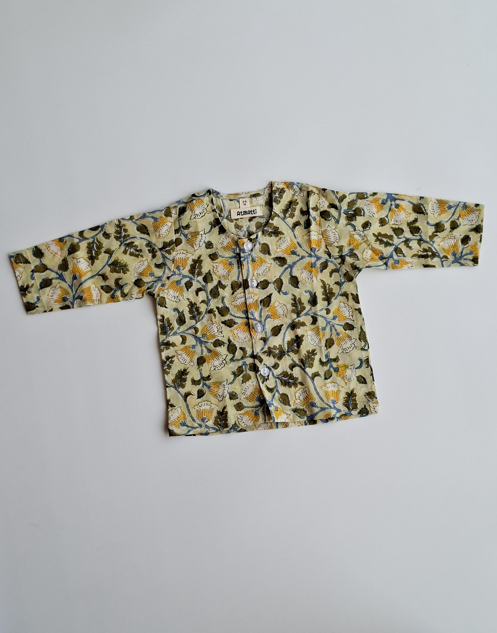 Yellow floral handblock printed mulmul cotton jhabla for newborn baby front view