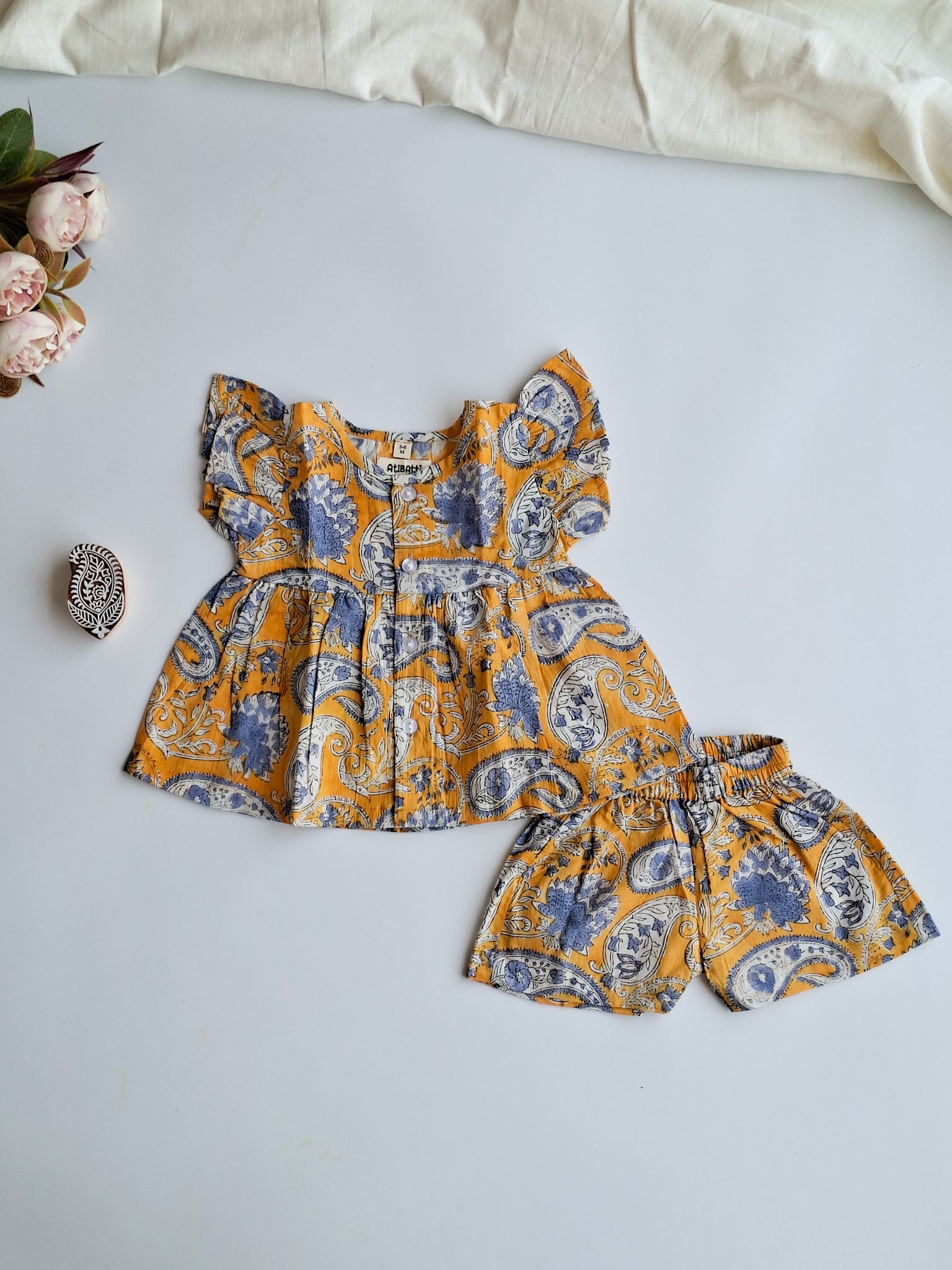 atibatti-newborn-dress-set-mustard-handblock-print-flat-lay