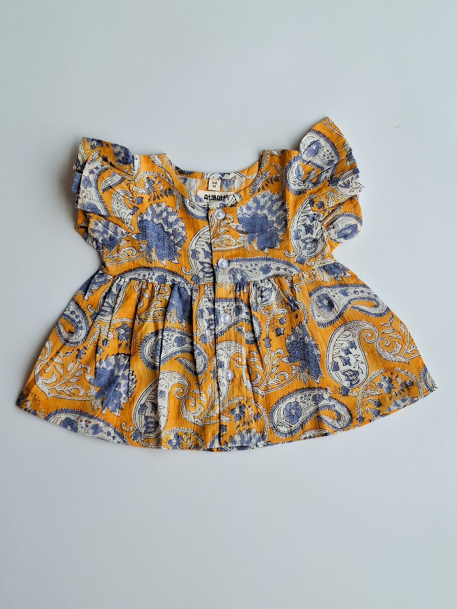 atibatti-newborn-dress-set-mustard-handblock-print-topview