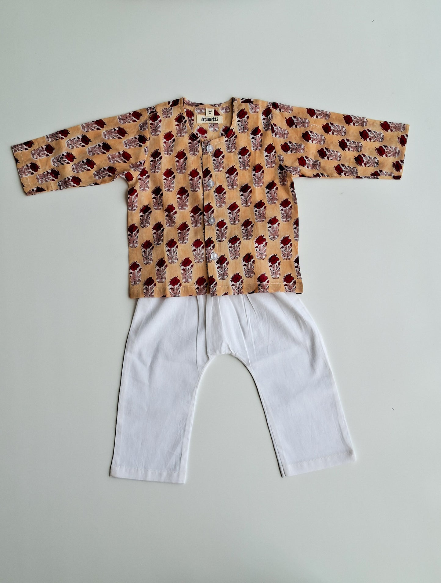 cream rose soft cotton jhabla for newborn with traditional Indian handblock print front view