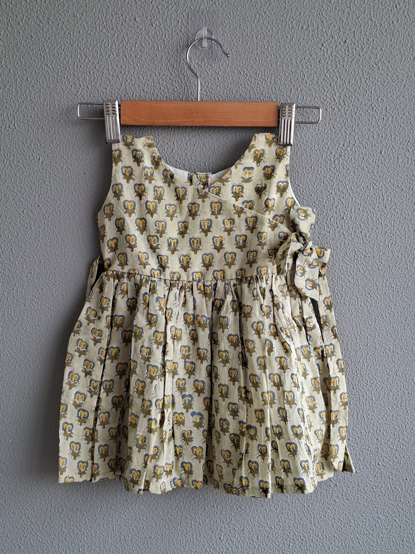 green handblock print baby girl cotton dress flat lay